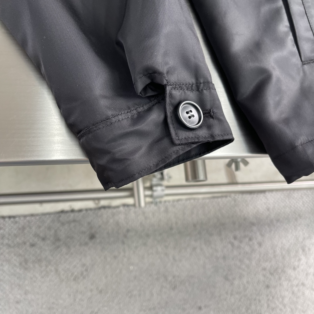 -PRAD 再生尼龙连帽夹克选用品牌标志性的再生尼龙面料，与传统尼龙性能相当，具备高强度，抗撕裂，耐磨损