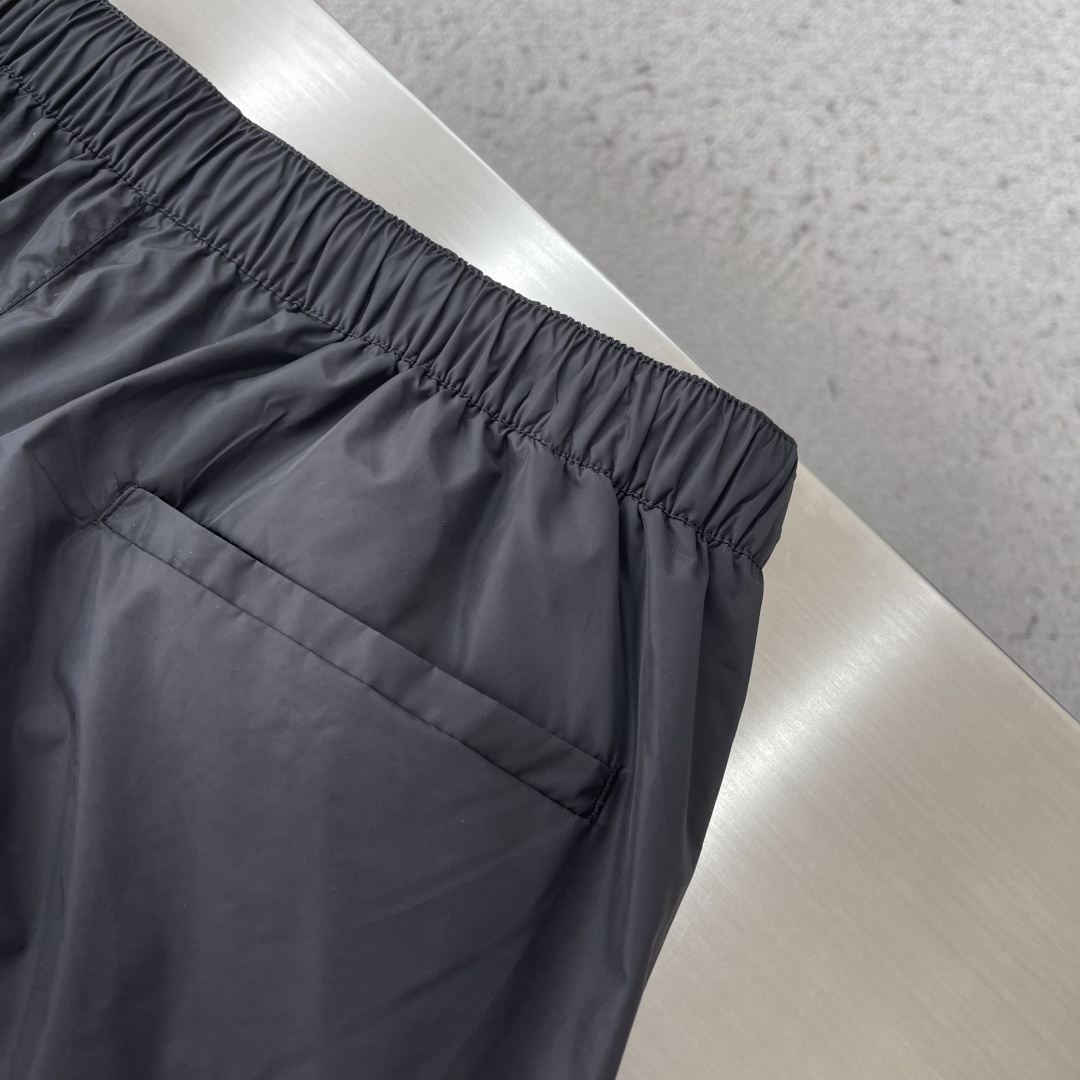 -PRAD 新款三角微标短裤。这款短裤采用流畅动感设计，选用创新的再生尼龙面料，成为Prad*系列的元素