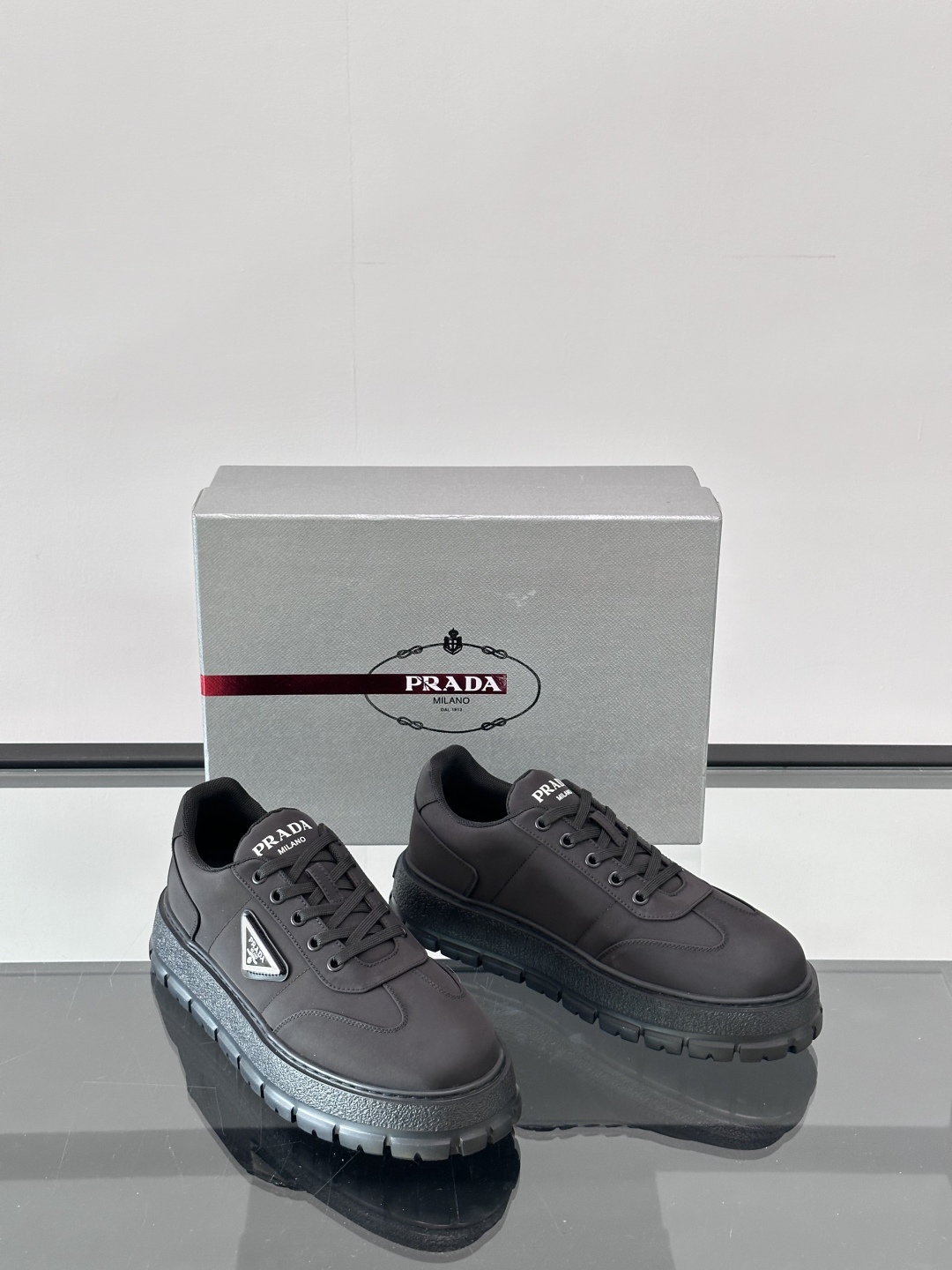 Prada/普拉达 男士新款运动休闲鞋，这款运动鞋鞋面采用科技面料。外侧饰以P家经典金属三角珐琅徽标，真