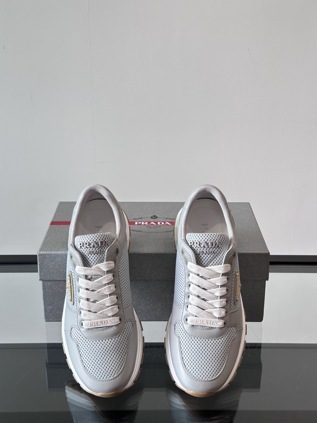 Prada/普拉达 男士新款运动休闲鞋，这款运动鞋鞋面采用进口小牛皮拼接透气网面，外侧饰以P家经典金属三