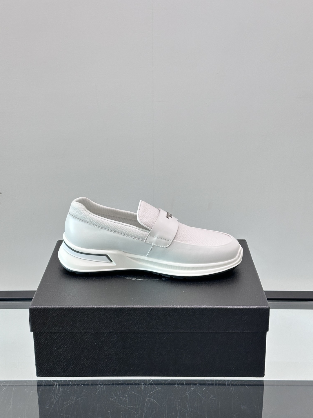 Prada/普拉达 男士新款一脚蹬懒人休闲鞋👟这款运动鞋采用光滑小牛皮革和摔纹牛皮拼接鞋面，一脚蹬乐福鞋