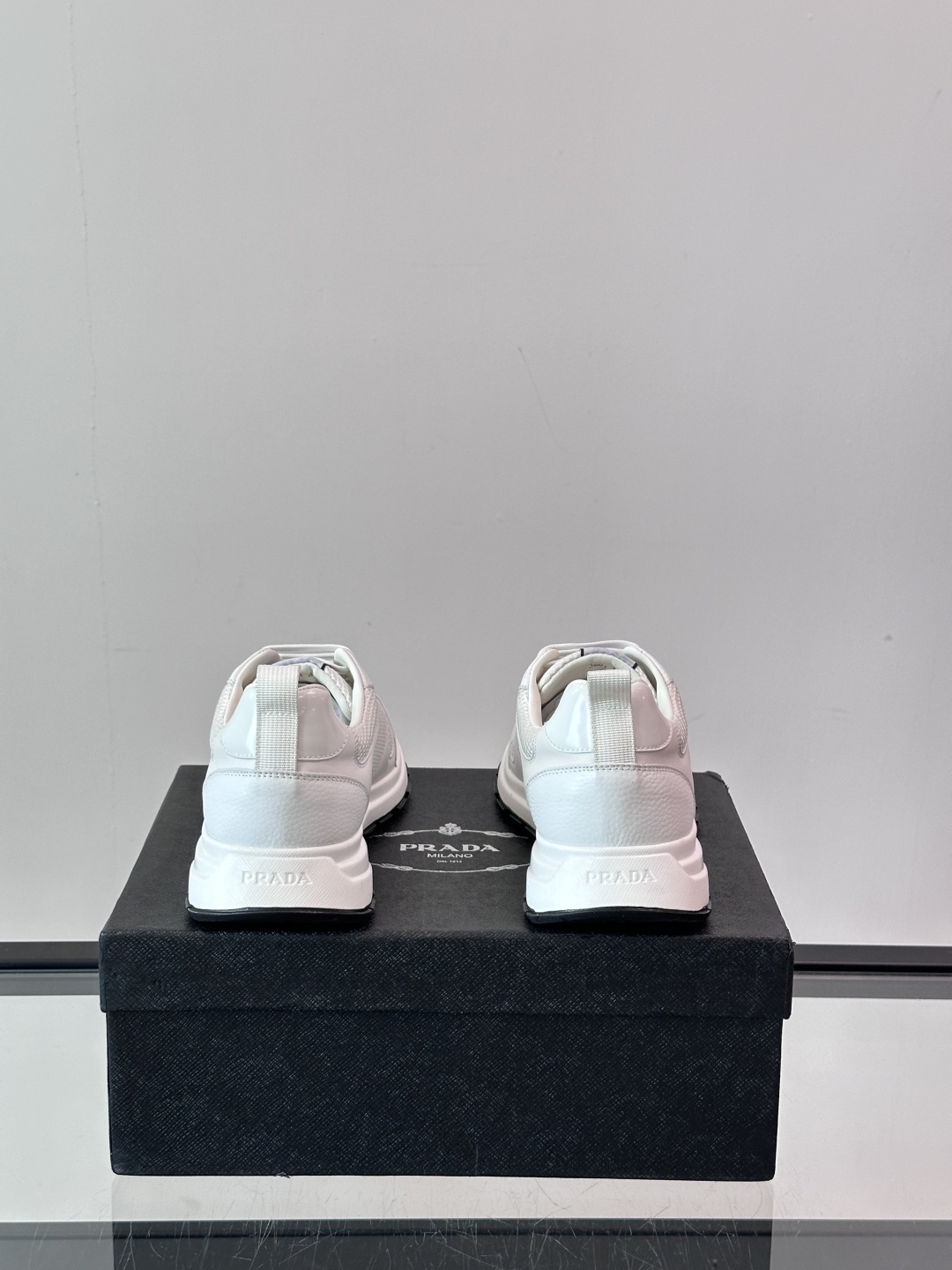 Prada/普拉达 男士新款运动休闲鞋，这款运动鞋鞋面采用进口小牛皮拼接透气网面，外侧饰以P家经典金属三