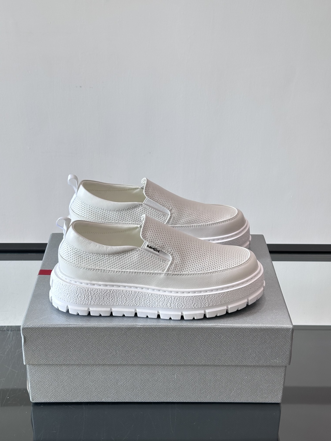 Prada/普拉达 男士新款一脚蹬懒人休闲鞋👟这款运动鞋采用光滑小牛皮革和摔纹牛皮拼接鞋面，一脚蹬乐福鞋