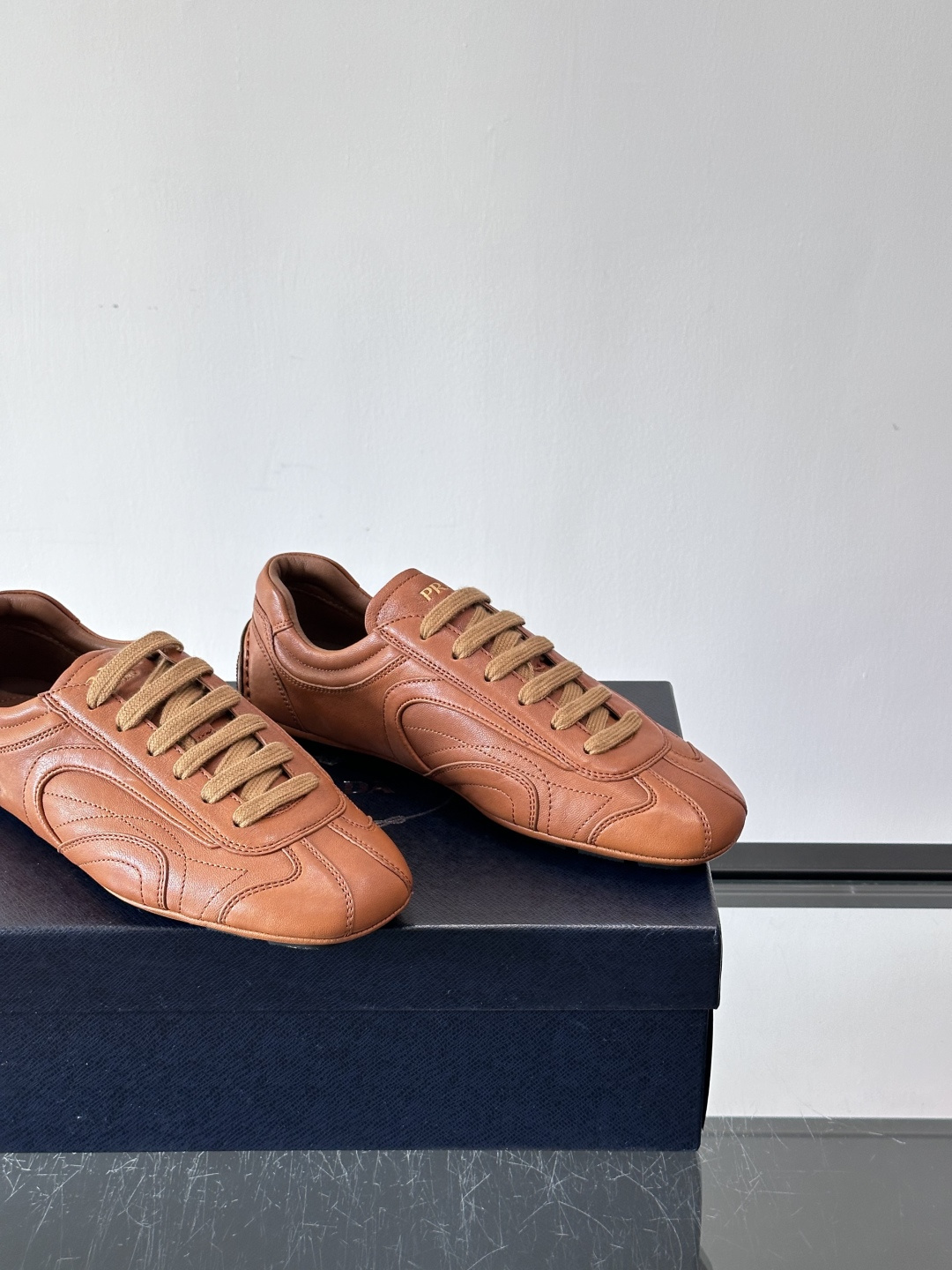 Prada Montecarlo男士薄底运动鞋，采用优质NaPPa皮革，质感细腻又耐用。灵感源自赛车运动