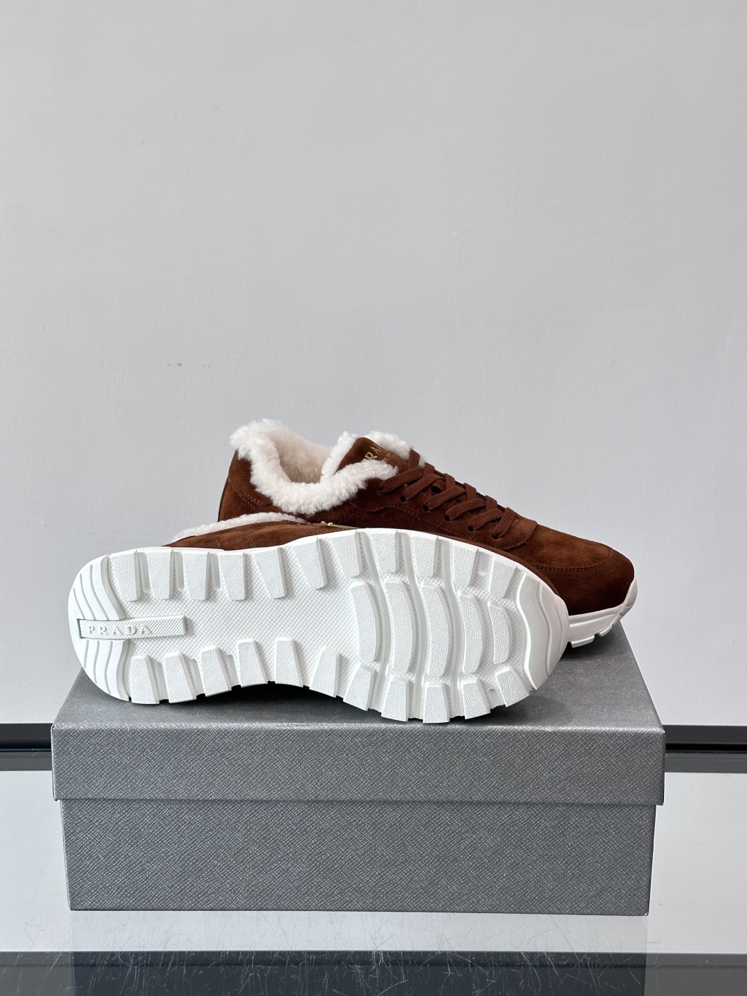 Prada新款翻毛牛皮天鹅绒运动鞋这款以绒面小牛皮打造的运动鞋完美地结合了复古韵味与现代审美。其鞋舌由柔