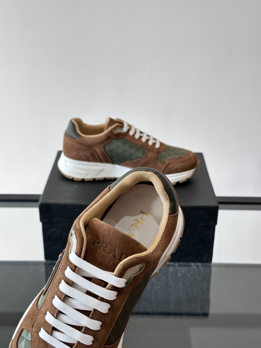Prada 男士休闲运动鞋。采用麂皮与尼龙面料拼接，质感柔软又耐用，低调奢华。鞋侧三角徽标超有辨识度，橡