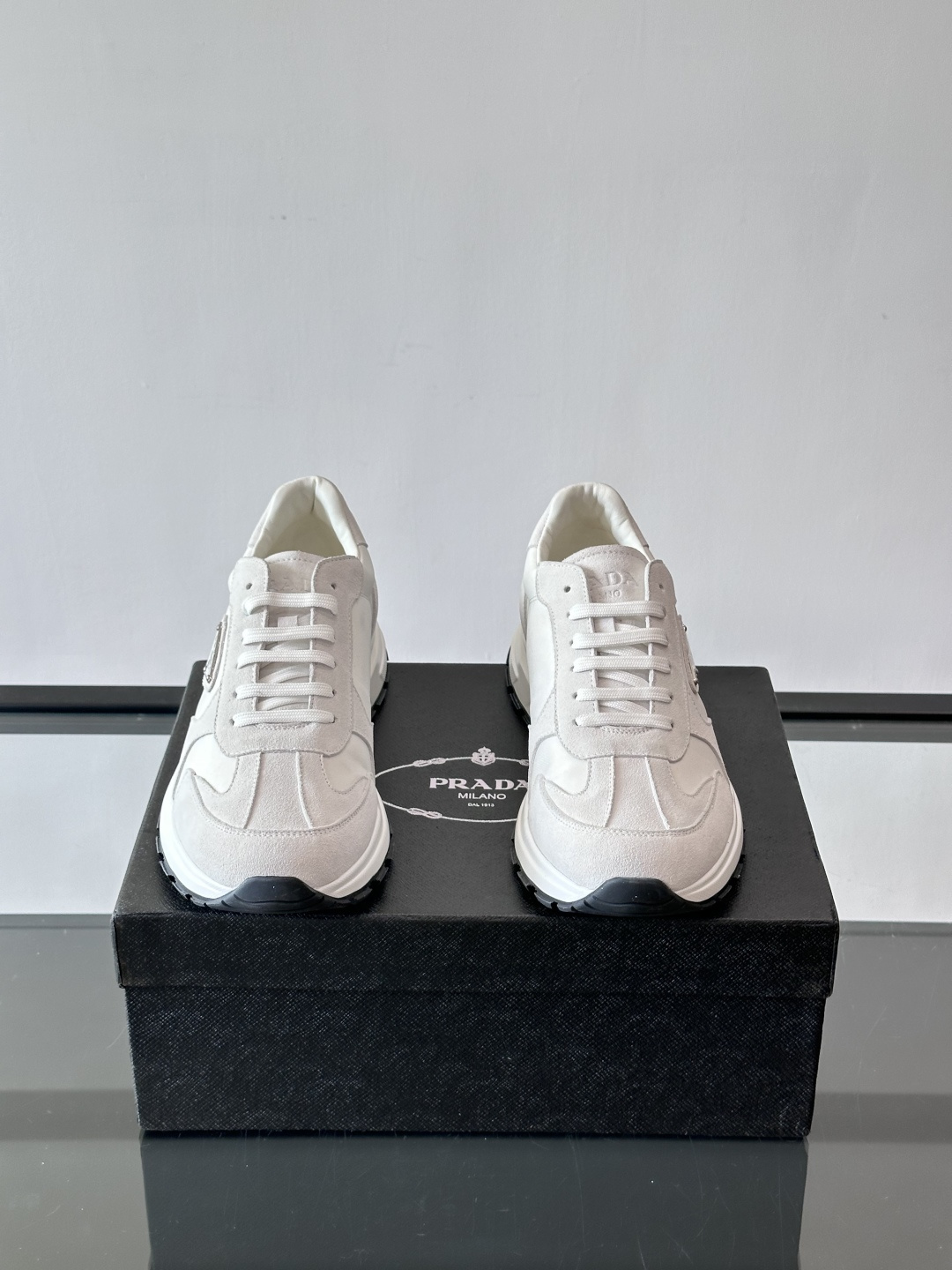 Prada 男士休闲运动鞋。采用麂皮与尼龙面料拼接，质感柔软又耐用，低调奢华。鞋侧三角徽标超有辨识度，橡