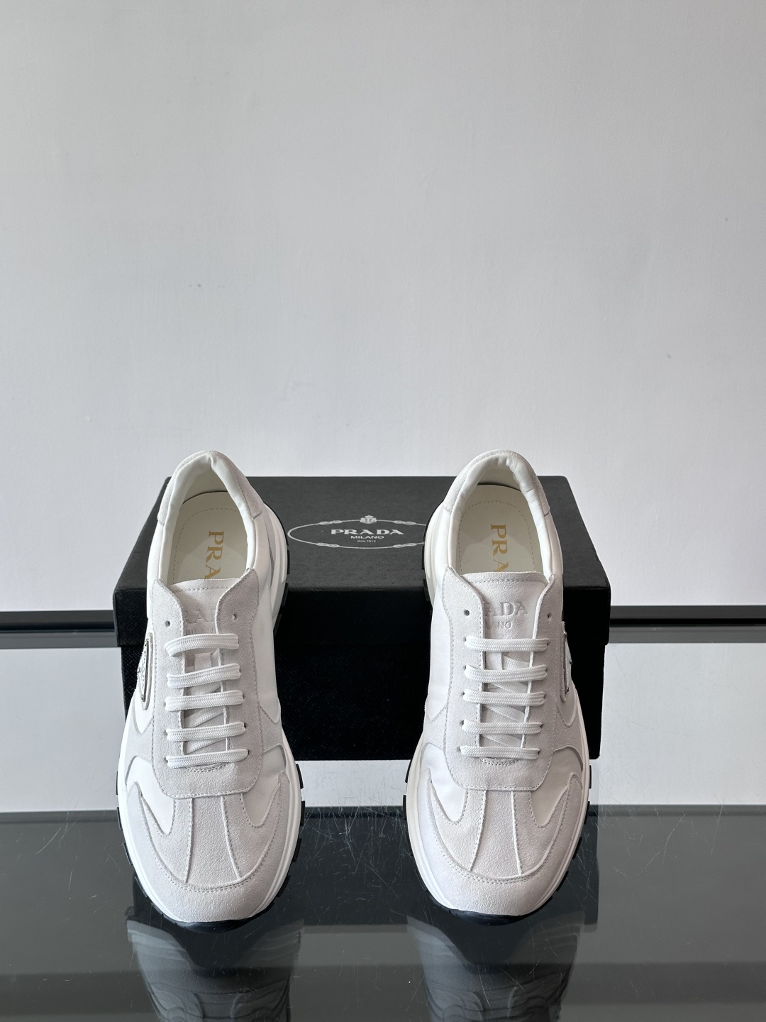 Prada 男士休闲运动鞋。采用麂皮与尼龙面料拼接，质感柔软又耐用，低调奢华。鞋侧三角徽标超有辨识度，橡