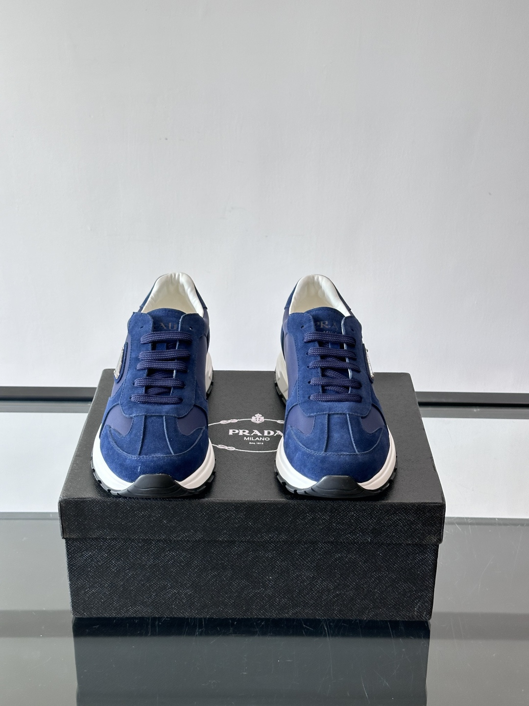 Prada 男士休闲运动鞋。采用麂皮与尼龙面料拼接，质感柔软又耐用，低调奢华。鞋侧三角徽标超有辨识度，橡