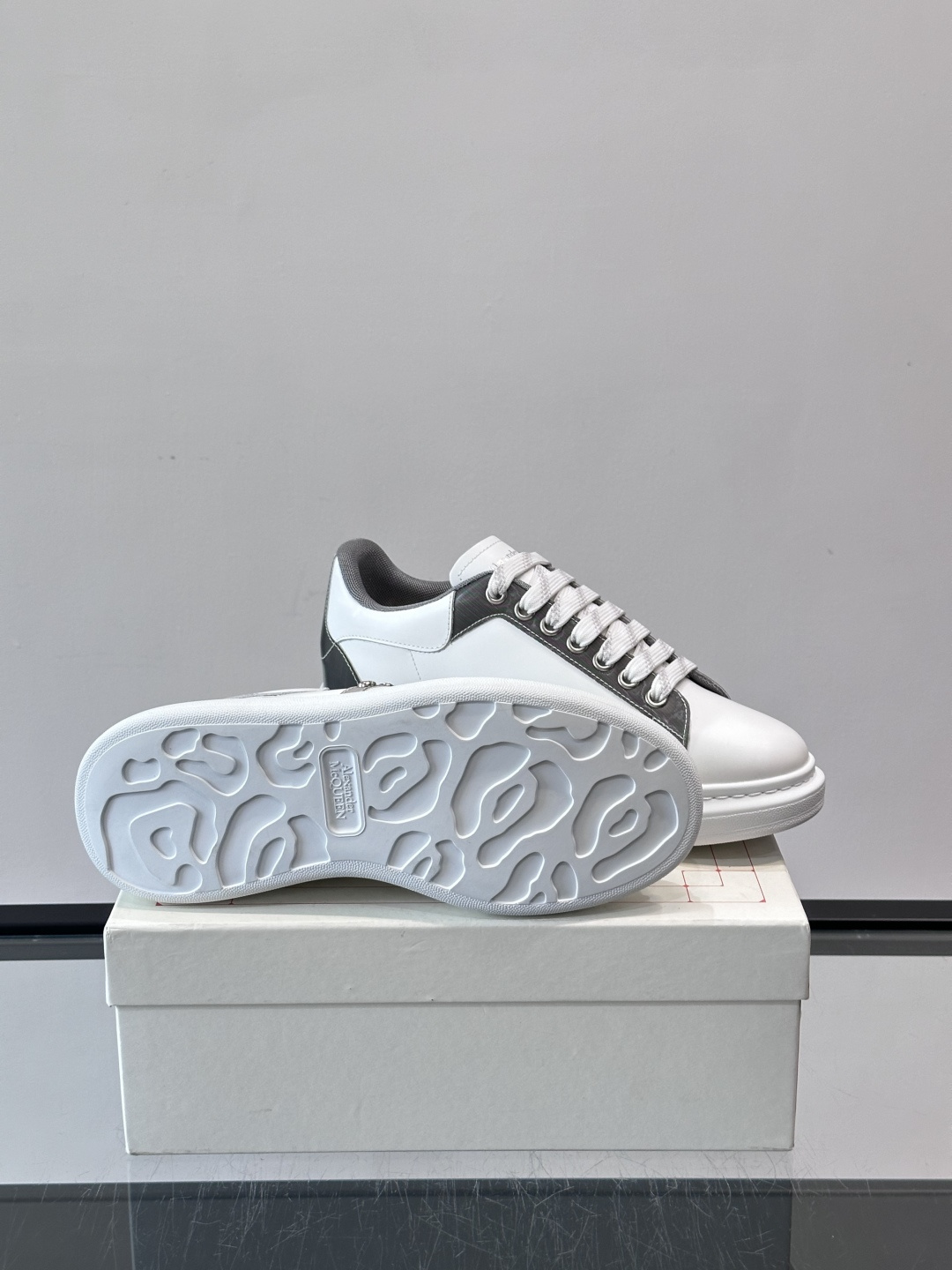 Alexander McQueen厚底休闲鞋，白色牛皮革鞋面+灰色拼接，简约又有层次感。鞋侧金属铆钉点缀