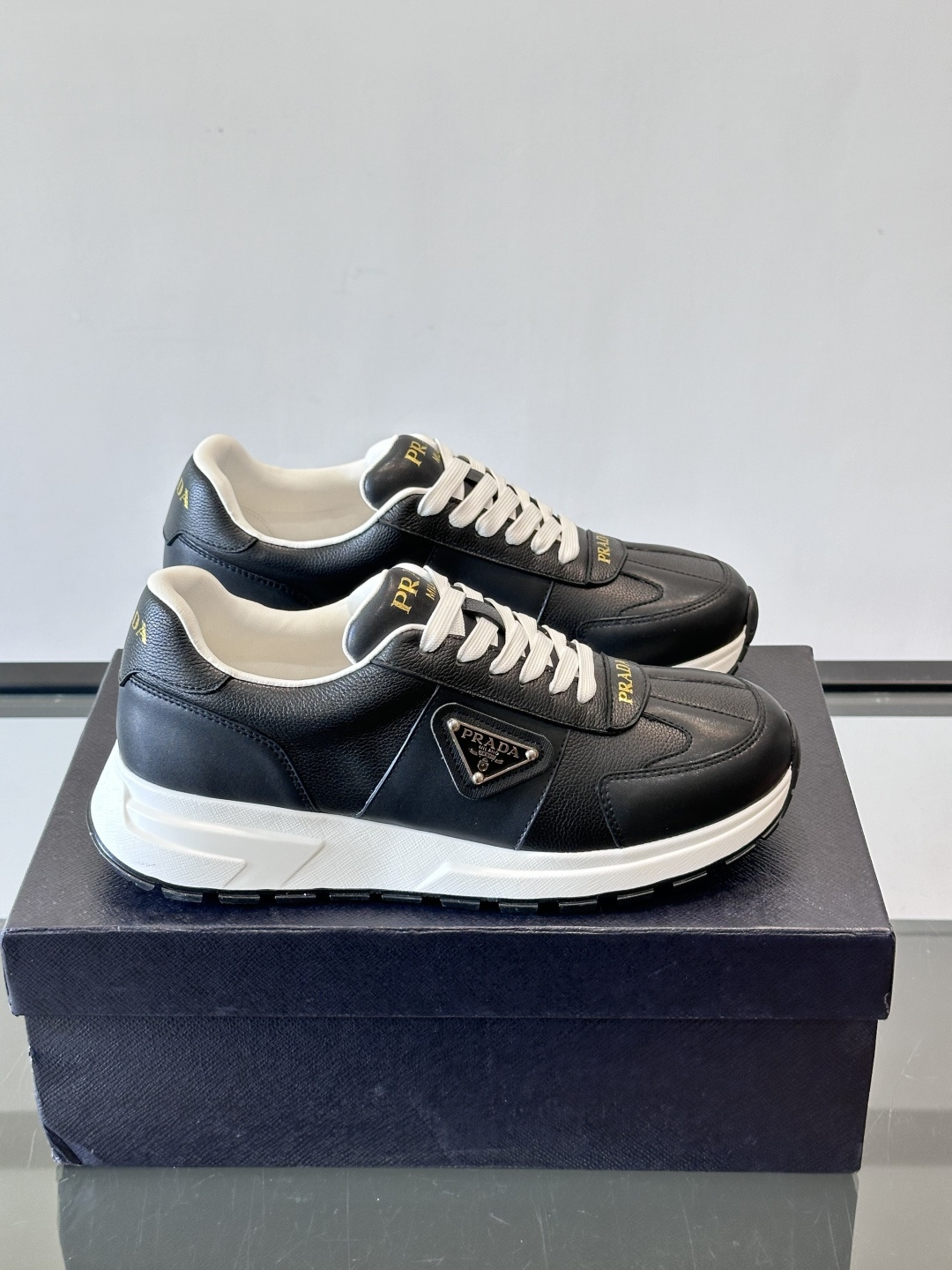 Prada这款运动鞋采用优质牛皮革，鞋面简约流畅，搭配经典三角Logo，低调又有辨识度。厚底设计，穿着舒