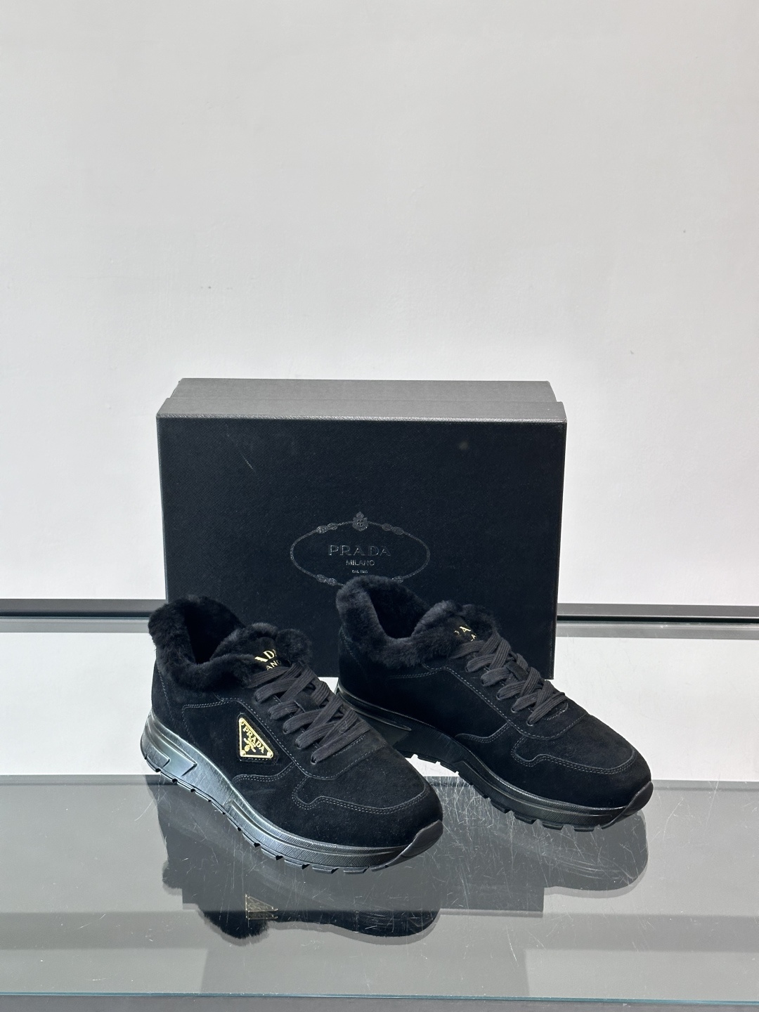 Prada新款翻毛牛皮天鹅绒运动鞋这款以绒面小牛皮打造的运动鞋完美地结合了复古韵味与现代审美。其鞋舌由柔