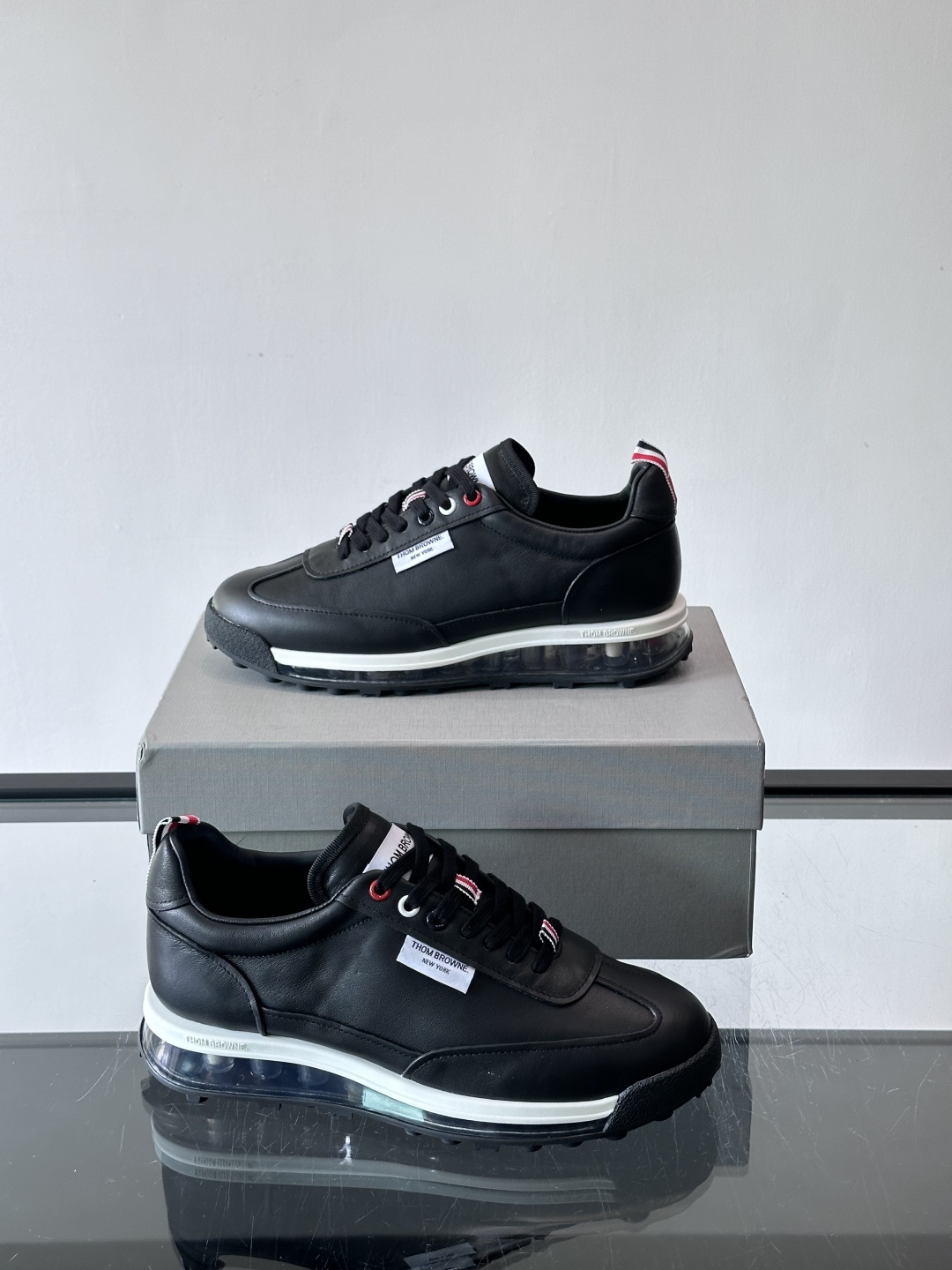 Thom Browne男士气垫休闲鞋，麂皮+牛皮拼接，质感细腻又透气。标志性红白蓝鞋带，辨识度超高。透明