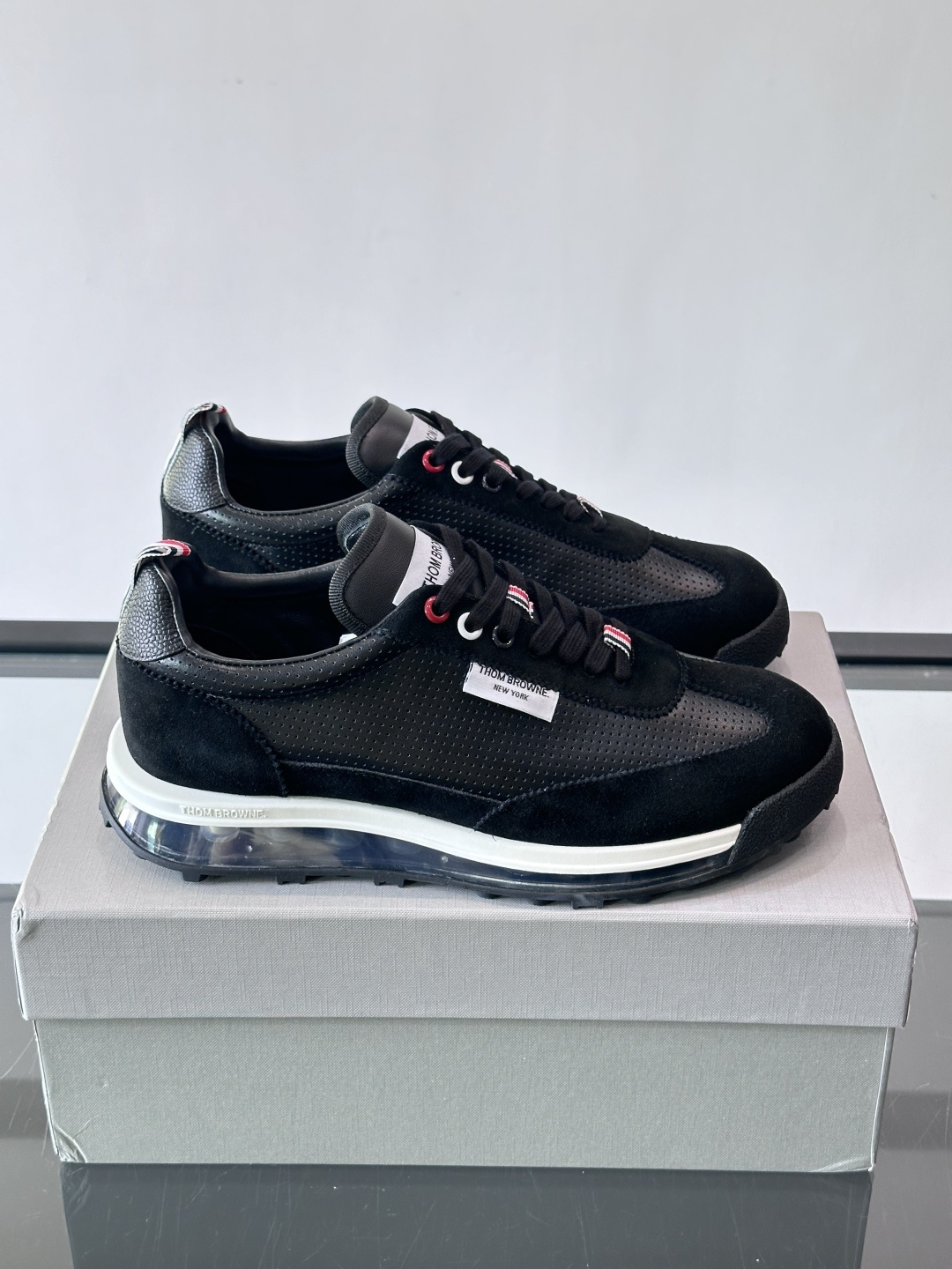 Thom Browne男士气垫休闲鞋，麂皮+牛皮拼接，质感细腻又透气。标志性红白蓝鞋带，辨识度超高。透明