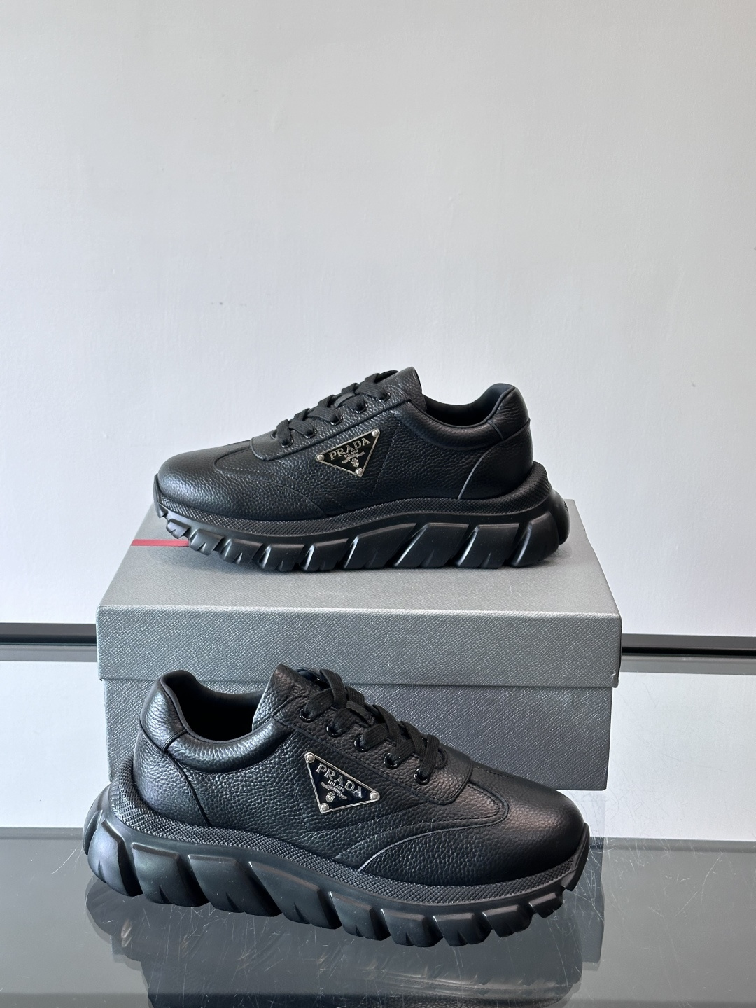 Prada男士休闲运动鞋，采用优质牛皮，鞋面柔软细腻，搭配经典三角金属Logo，品牌辨识度超高✨。厚底设