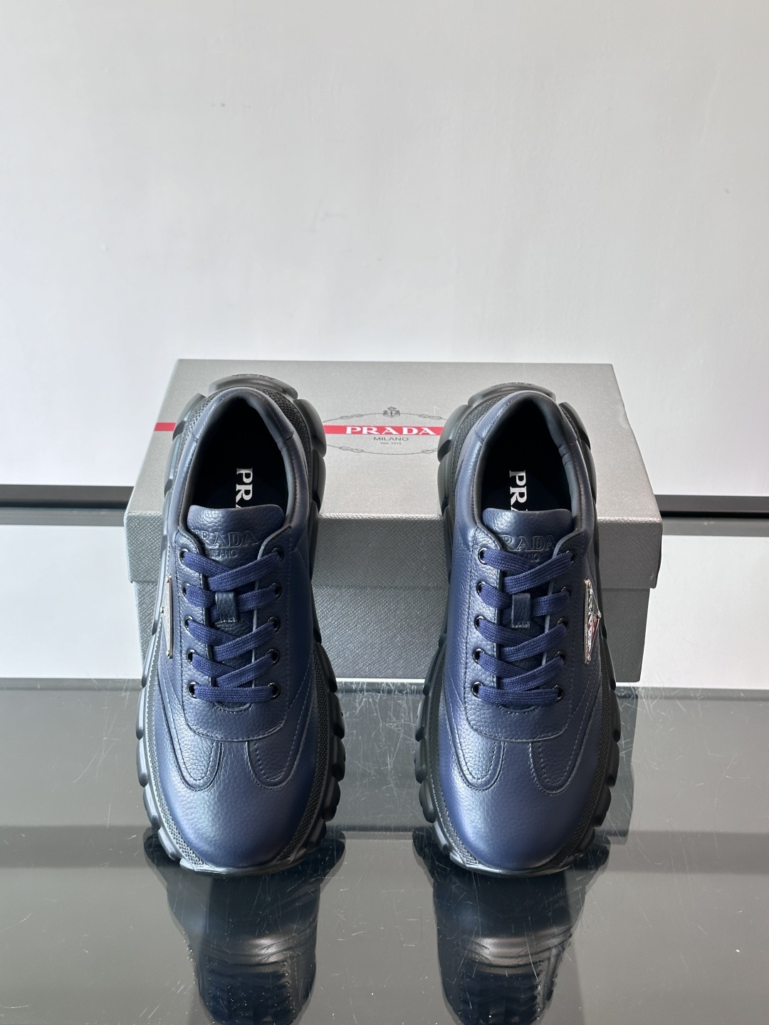 Prada男士休闲运动鞋，采用优质牛皮，鞋面柔软细腻，搭配经典三角金属Logo，品牌辨识度超高✨。厚底设