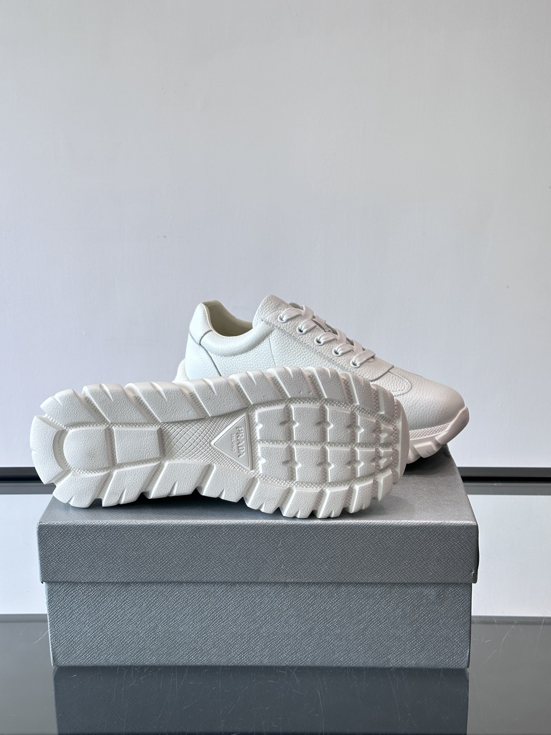 Prada男士休闲运动鞋，采用优质牛皮，鞋面柔软细腻，搭配经典三角金属Logo，品牌辨识度超高✨。厚底设