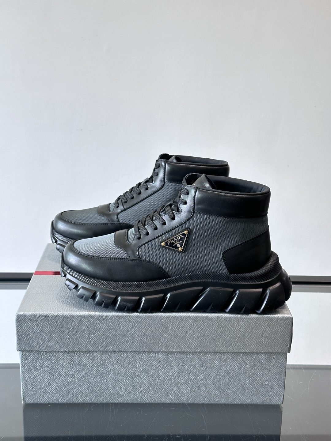 Prada 男士高帮运动鞋，牛皮+单宁布拼接，质感满分！鞋侧珐琅金属三角徽标超有辨识度✨，凹凸纹橡胶厚底