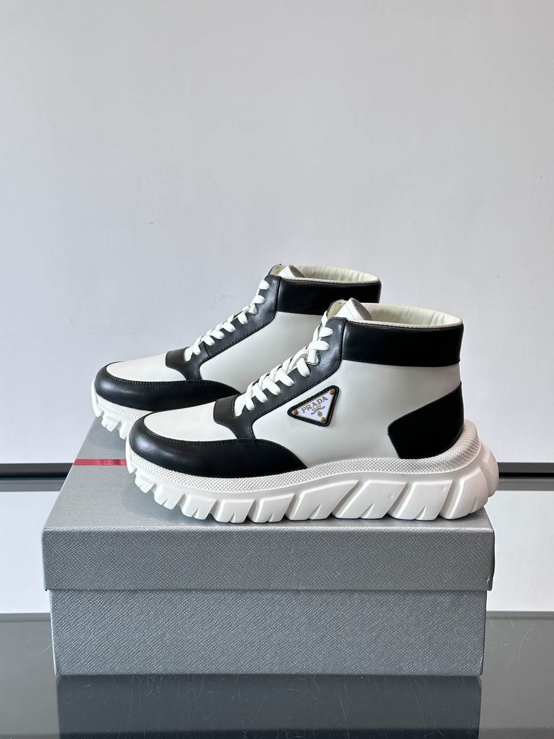 Prada三角标厚底运动鞋，高帮设计，纳帕小牛皮鞋面，柔软细腻质感满分✨。侧面三角金属珐琅徽章+鞋舌&后