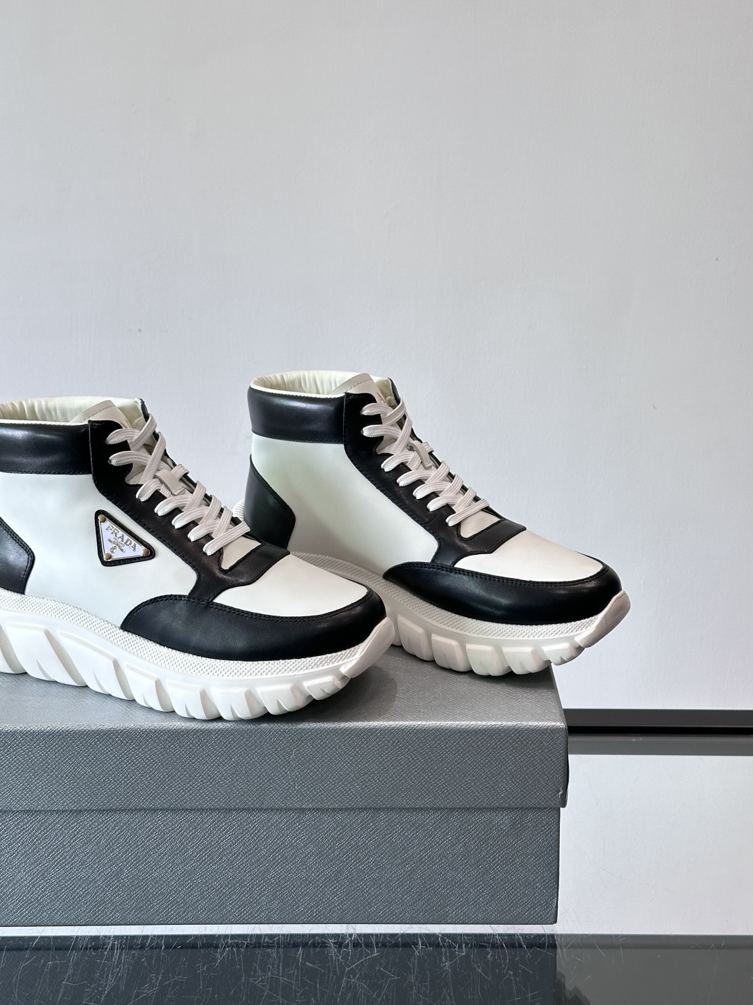 Prada三角标厚底运动鞋，高帮设计，纳帕小牛皮鞋面，柔软细腻质感满分✨。侧面三角金属珐琅徽章+鞋舌&后