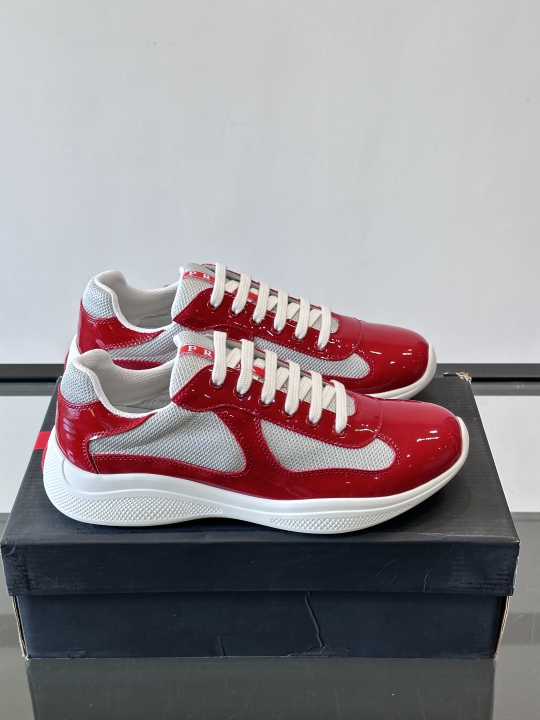 Prada 美洲杯运动鞋​​✨Prada美洲杯系列运动鞋，漆皮+网面拼接，光泽感与透气性兼具。低帮设计，