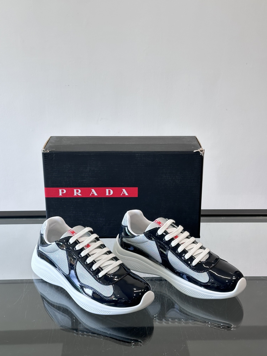 Prada 美洲杯运动鞋​​✨Prada美洲杯系列运动鞋，漆皮+网面拼接，光泽感与透气性兼具。低帮设计，
