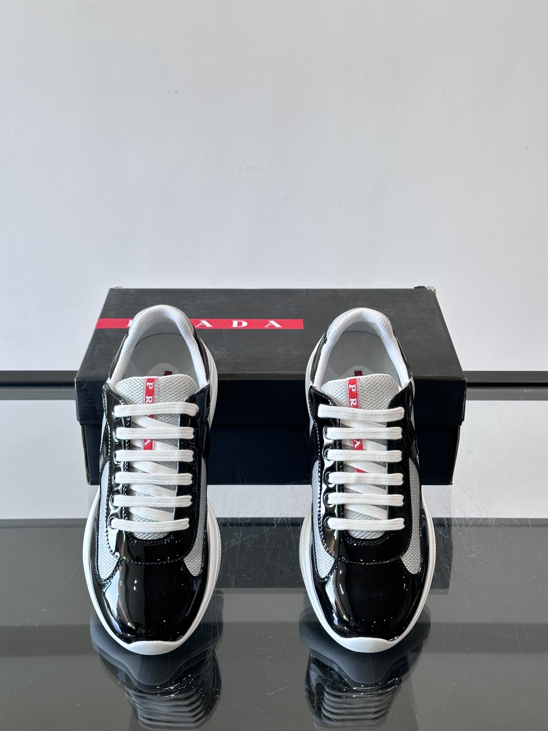Prada 美洲杯运动鞋​​✨Prada美洲杯系列运动鞋，漆皮+网面拼接，光泽感与透气性兼具。低帮设计，
