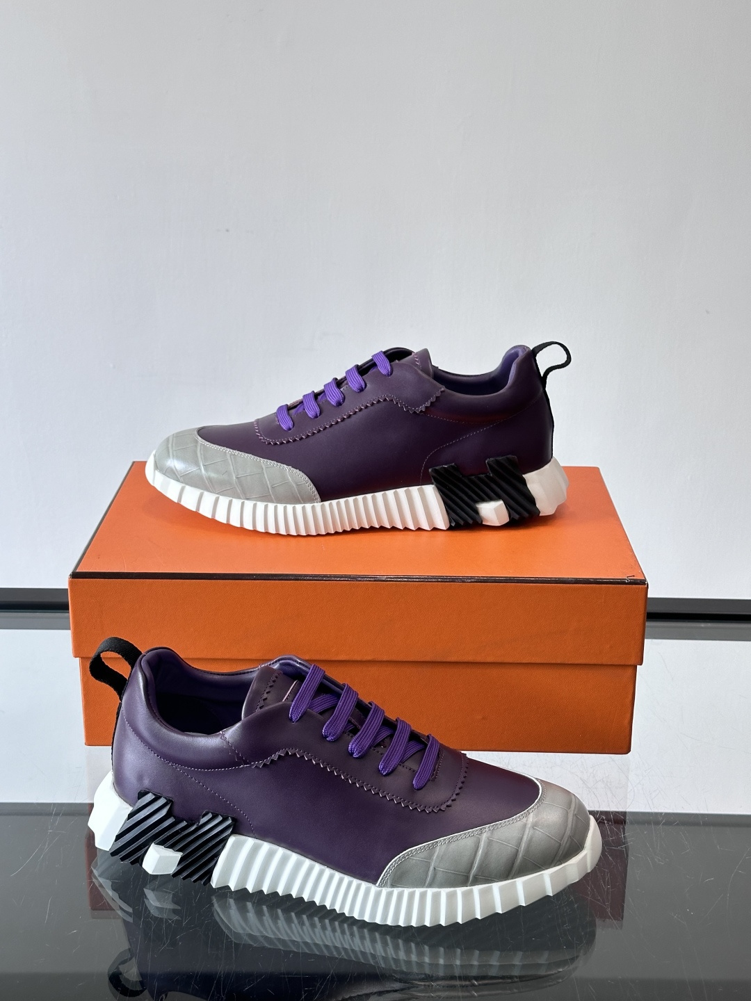 H爱马仕这双鞋是经典的鳄鱼纹运动鞋，鞋面采用仿鳄鱼皮纹理设计，搭配标志性的锯齿状厚底，整体风格兼具奢华感