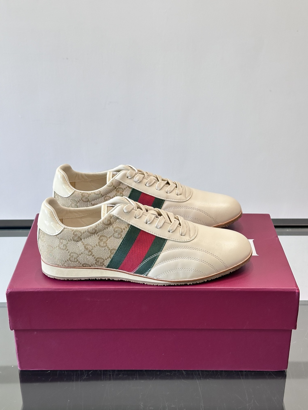 Gucci经典的复古运动鞋，采用皮革与GG老花帆布拼接设计，侧面饰有品牌标志性的红绿织带，鞋型圆润复古，