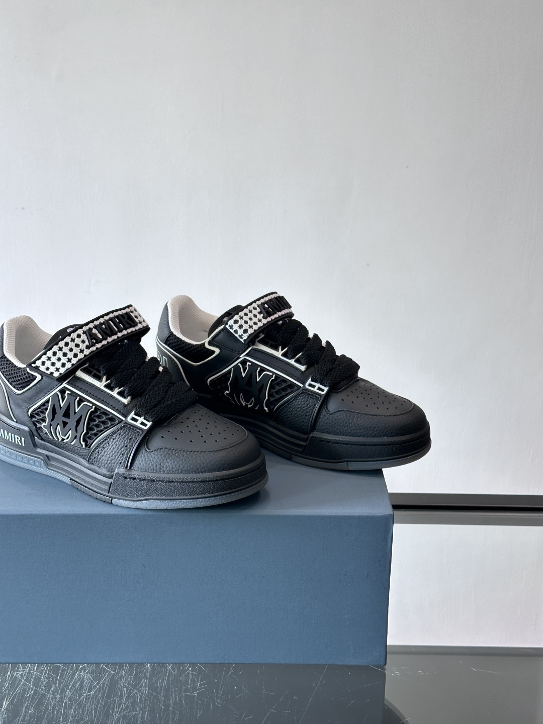 AMIRI拼色运动鞋​，这双AMIRI拼色运动鞋是品牌标志性的复古街头风格代表，采用经典黑白撞色设计，搭