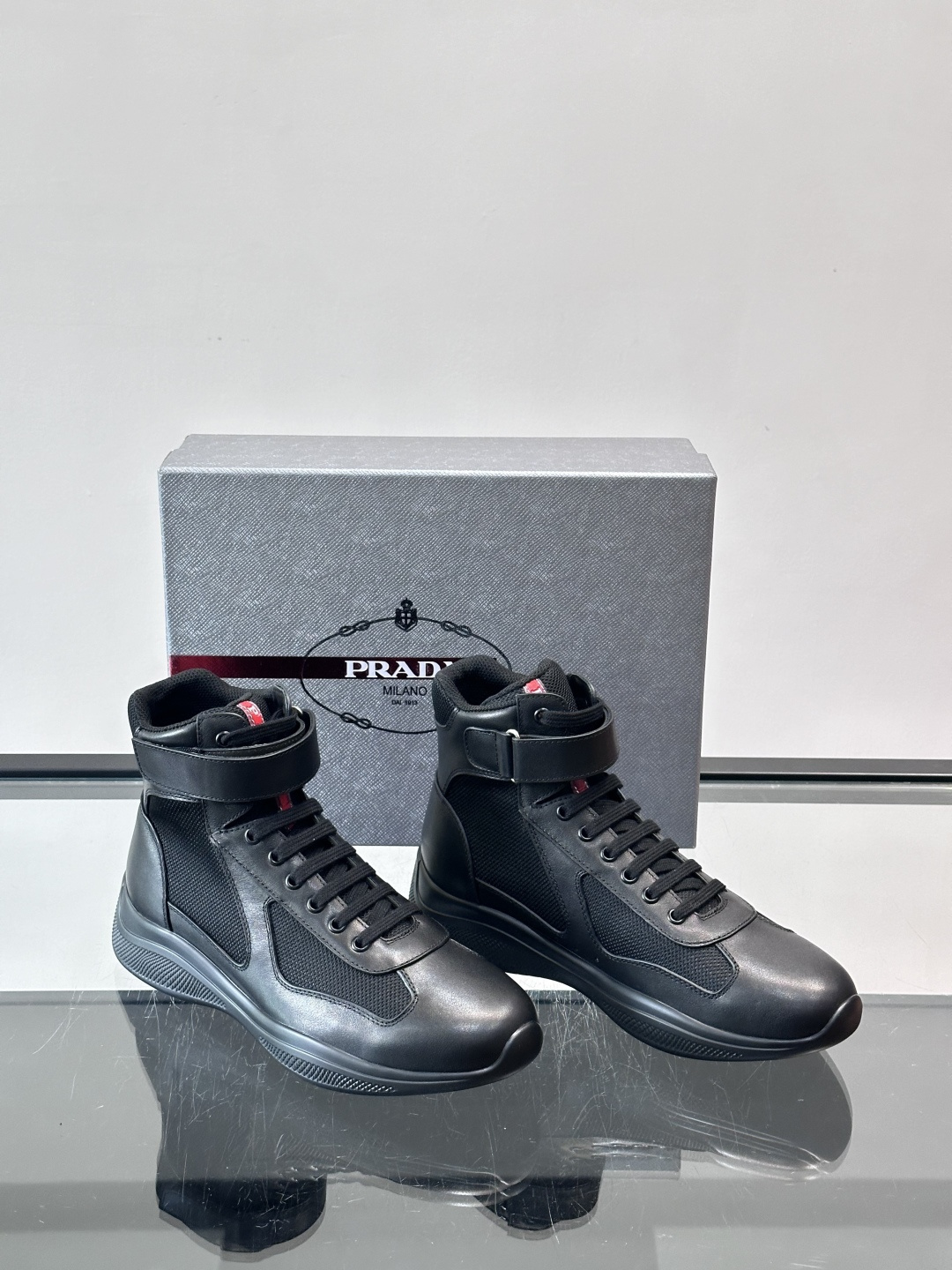 Prada 美洲杯高帮运动鞋​​✨Prada美洲杯系列运动鞋，漆皮+网面拼接，光泽感与透气性兼具。高帮设