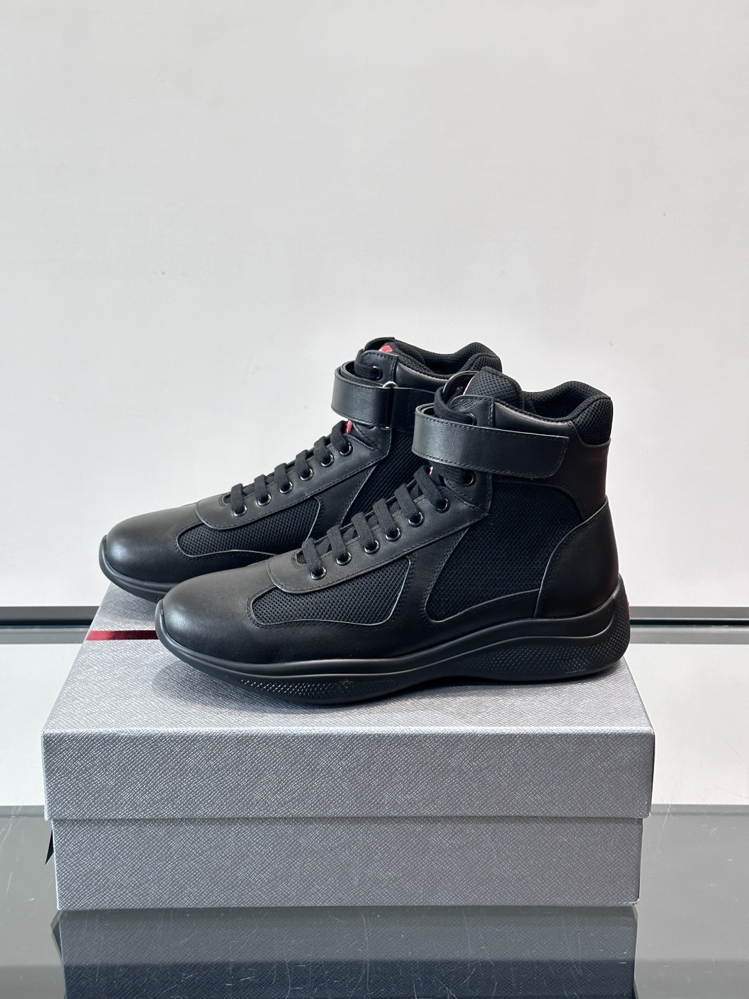 Prada 美洲杯高帮运动鞋​​✨Prada美洲杯系列运动鞋，漆皮+网面拼接，光泽感与透气性兼具。高帮设