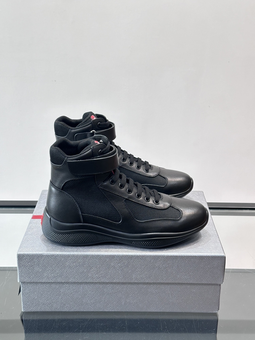 Prada 美洲杯高帮运动鞋​​✨Prada美洲杯系列运动鞋，漆皮+网面拼接，光泽感与透气性兼具。高帮设