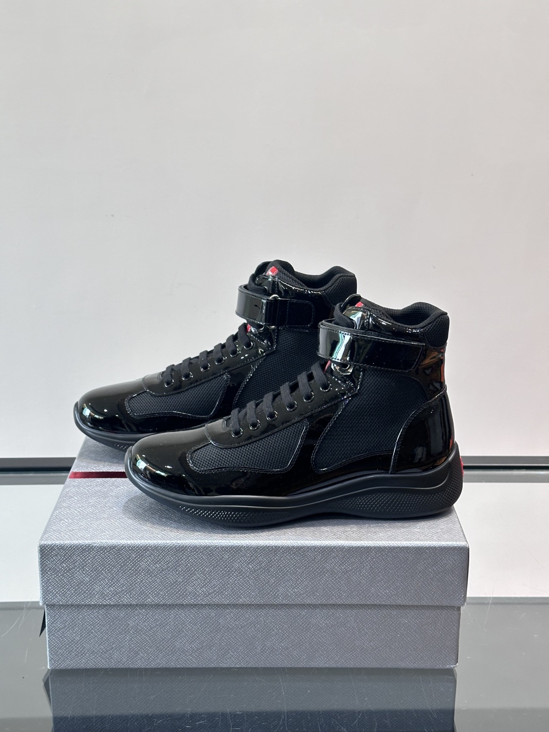 Prada 美洲杯高帮运动鞋​​✨Prada美洲杯系列运动鞋，漆皮+网面拼接，光泽感与透气性兼具。高帮设