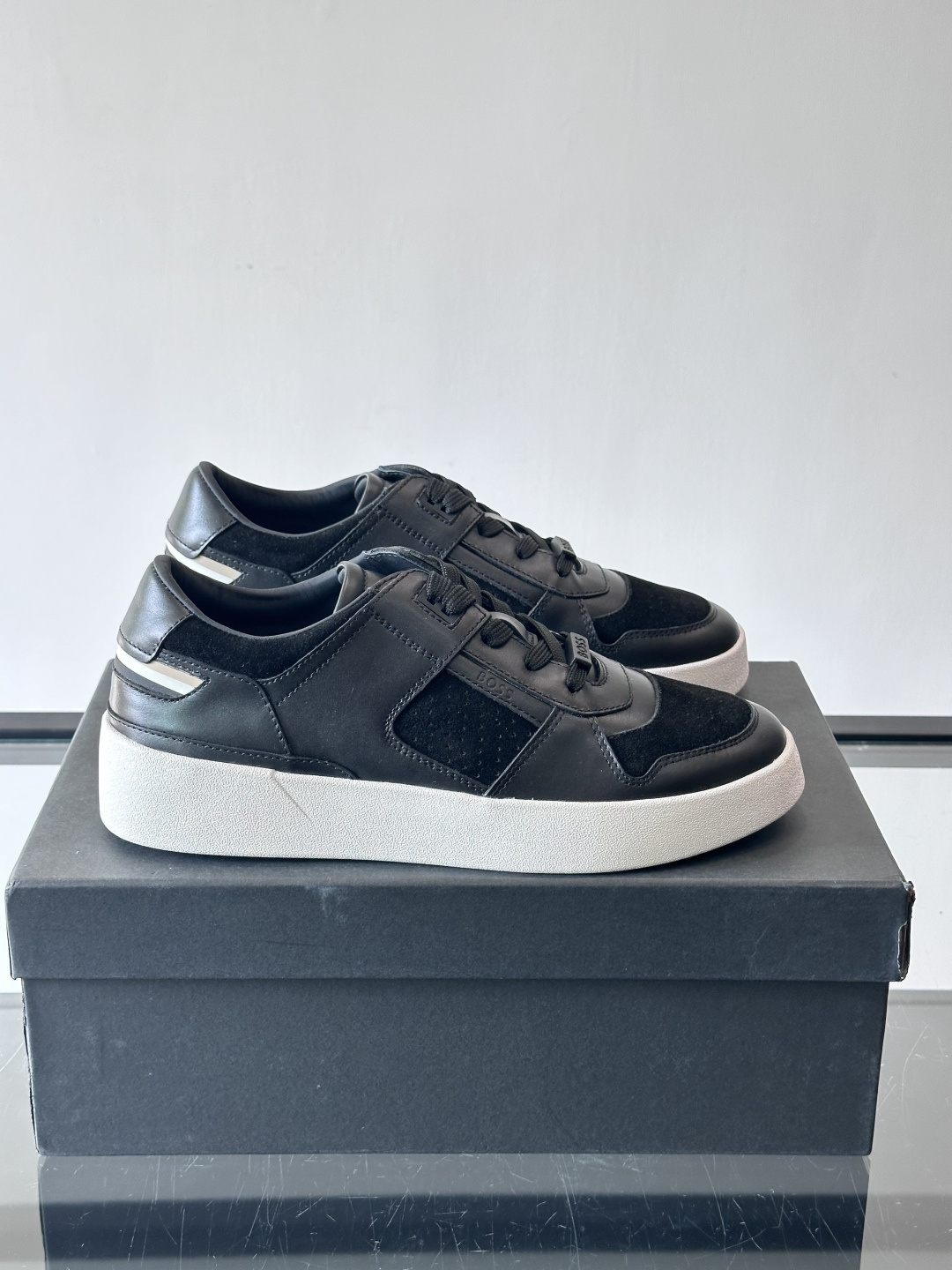 boss男士拼接休闲运动鞋，采用皮革+麂皮材质，质感细腻又耐用。鞋面简约，透气孔设计提升舒适度，橡胶鞋底