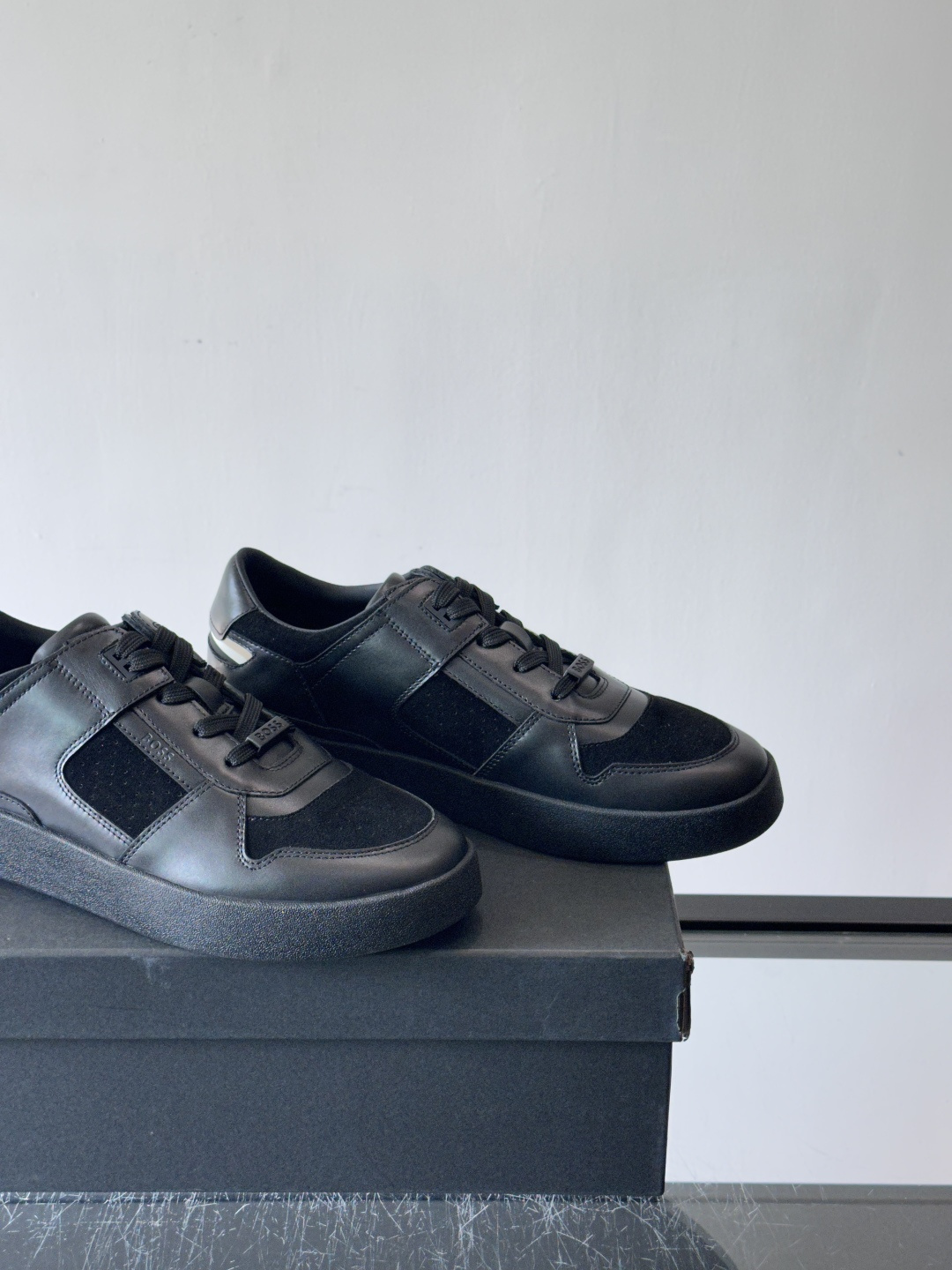 boss男士拼接休闲运动鞋，采用皮革+麂皮材质，质感细腻又耐用。鞋面简约，透气孔设计提升舒适度，橡胶鞋底