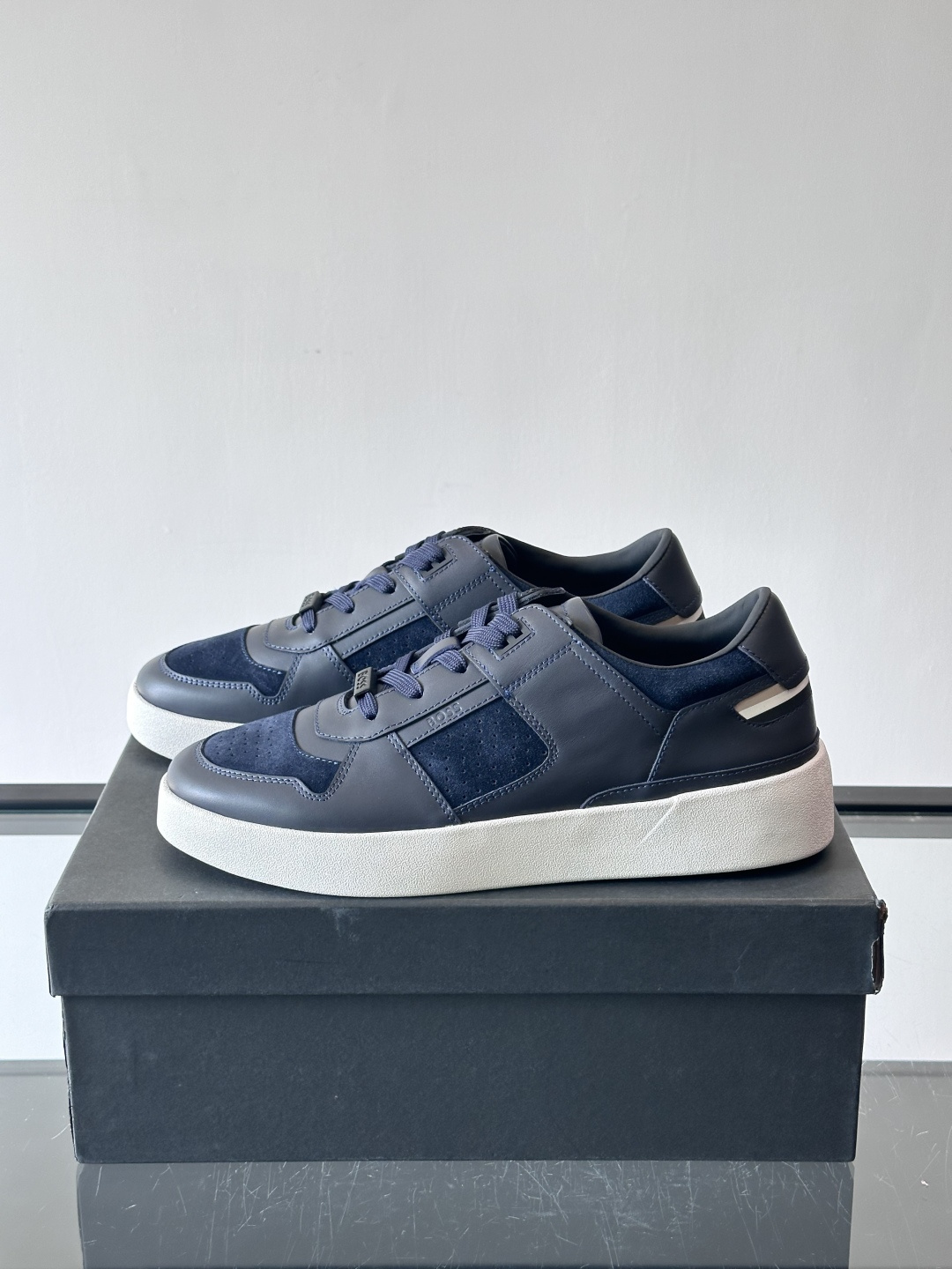 boss男士拼接休闲运动鞋，采用皮革+麂皮材质，质感细腻又耐用。鞋面简约，透气孔设计提升舒适度，橡胶鞋底