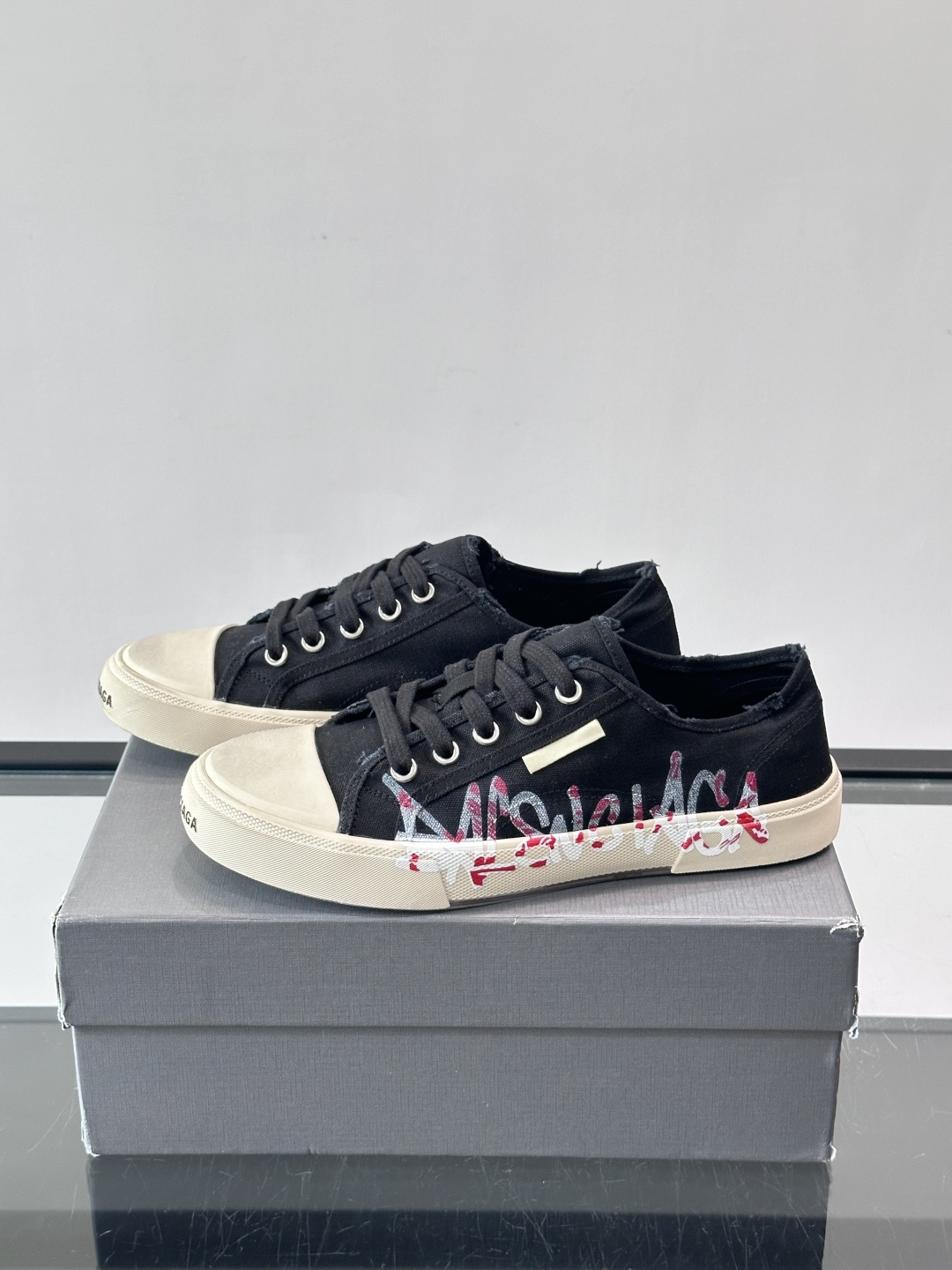 Balenciaga巴黎世家这款低帮帆布板鞋，鞋身搭配红黑涂鸦logo，街头感十足！鞋面是帆布材质，橡胶