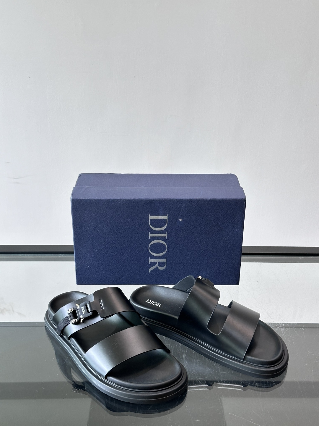 Dior Aqua 男士凉鞋拖鞋。展现 Dior 高订风格设计。迪奥灰绒面革饰带点缀以铝质 Dior 搭扣提升格调。搭配