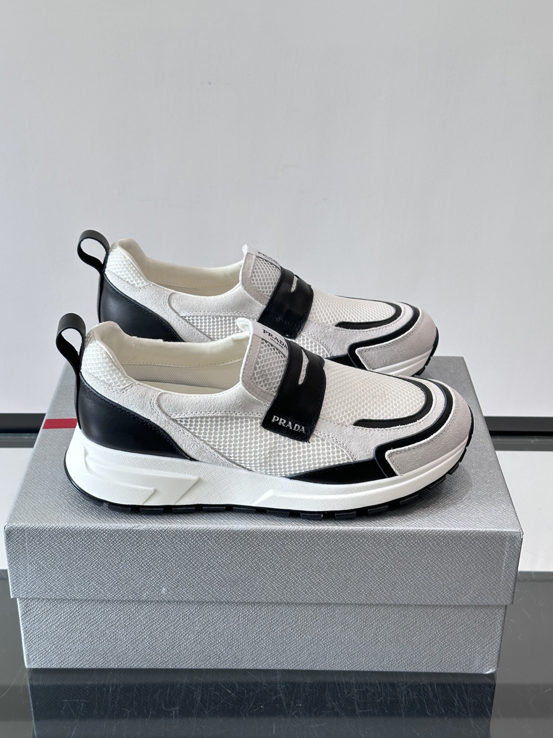 Prada/普拉达 男士新款一脚蹬懒人休闲鞋👟这款运动鞋采用光滑小牛皮革➕透气网面，一脚蹬乐福鞋鞋面，现代简约风格，舒适