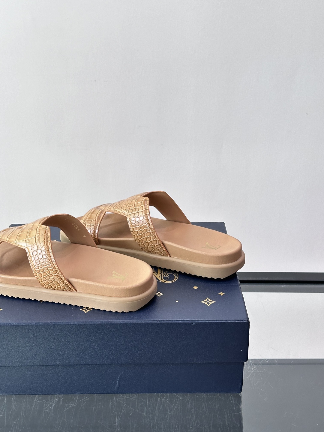 Louis Vuitton 男士皮革拖鞋​​，牛皮交叉带搭配防滑橡胶厚底，鞋垫上有 LV 暗纹 logo。 这款走的是"
