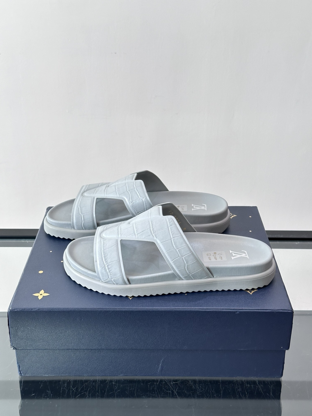 Louis Vuitton 男士皮革拖鞋​​，牛皮交叉带搭配防滑橡胶厚底，鞋垫上有 LV 暗纹 logo。 这款走的是"