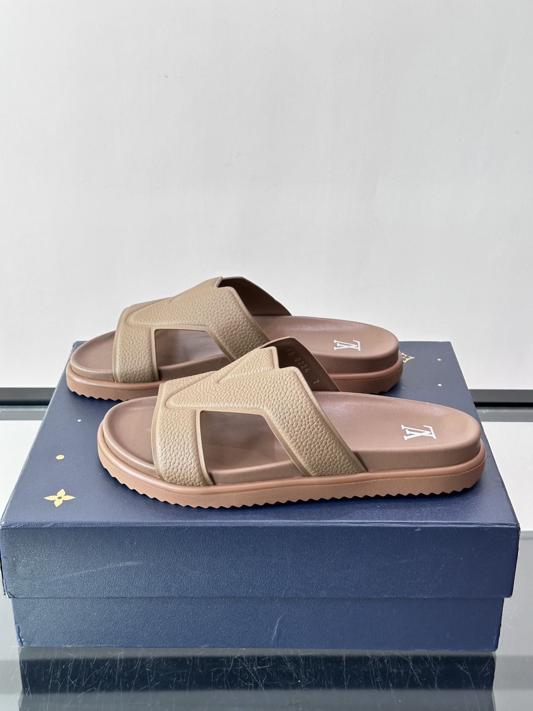 Louis Vuitton 男士皮革拖鞋​​，牛皮交叉带搭配防滑橡胶厚底，鞋垫上有 LV 暗纹 logo。 这款走的是"