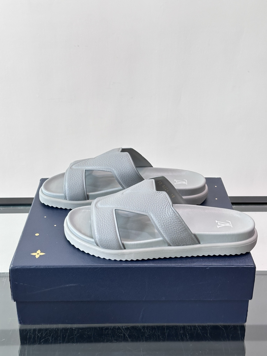 Louis Vuitton 男士皮革拖鞋​​，牛皮交叉带搭配防滑橡胶厚底，鞋垫上有 LV 暗纹 logo。 这款走的是"