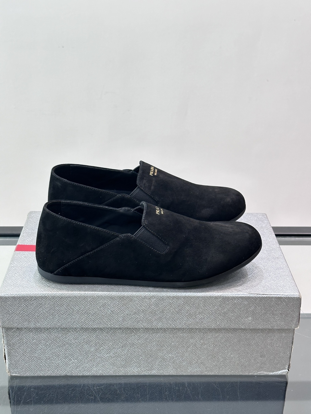 Prada 麂皮一脚蹬乐福鞋,翻毛皮鞋面,鞋面顶部有金色"PRADA MILANO"字样烫印,鞋垫上也是 PRA Prada 麂皮一脚蹬乐福鞋,翻毛皮鞋面,鞋面顶部有金色"PRADA MILANO"字样烫印,鞋垫上也是 PRA
