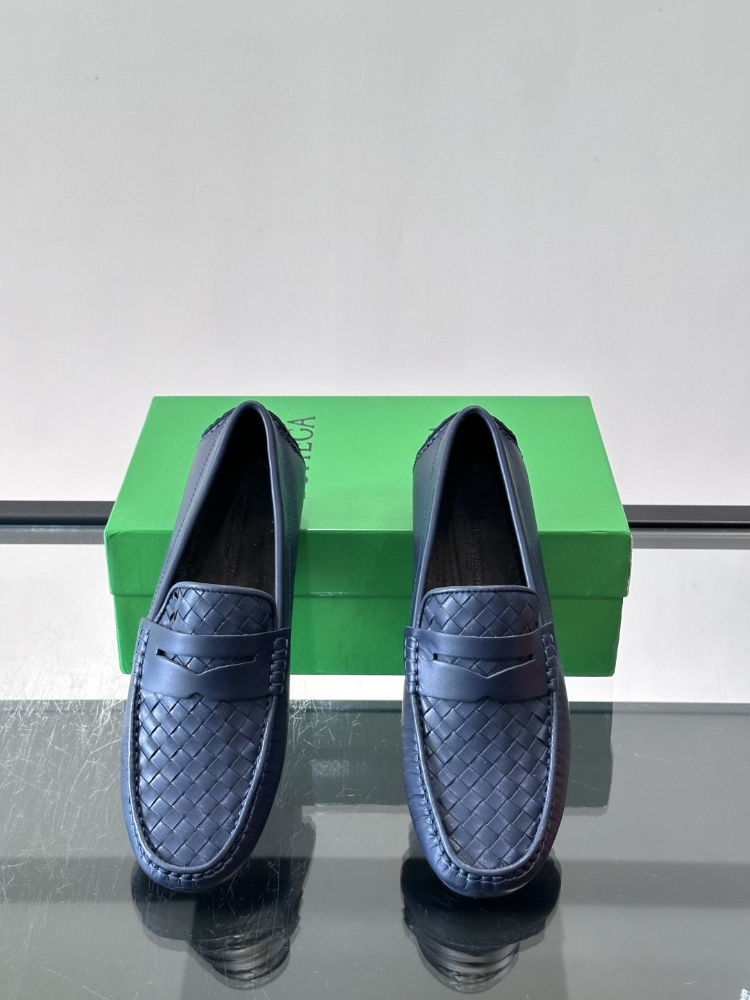 Bottega Veneta 编织豆豆鞋,编织皮革鞋面,橡胶豆豆颗粒鞋底,包边缝线细节。背景能看到 BV 的经典绿 Bottega Veneta 编织豆豆鞋,编织皮革鞋面,橡胶豆豆颗粒鞋底,包边缝线细节。背景能看到 BV 的经典绿