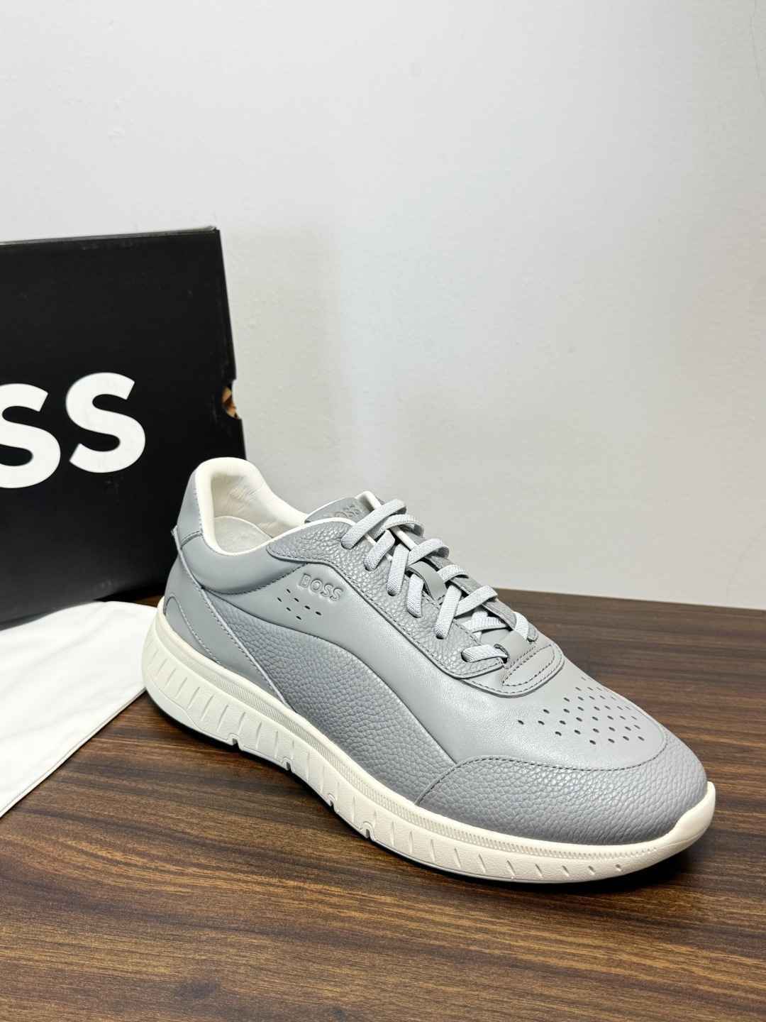 Hugo Boss 男士皮质休闲板鞋,鞋面是 荔枝纹牛皮 / 纳帕皮 ,鞋身有透气打孔设计,侧面压印或金属 BOSS Hugo Boss 男士皮质休闲板鞋,鞋面是 荔枝纹牛皮 / 纳帕皮 ,鞋身有透气打孔设计,侧面压印或金属 BOSS