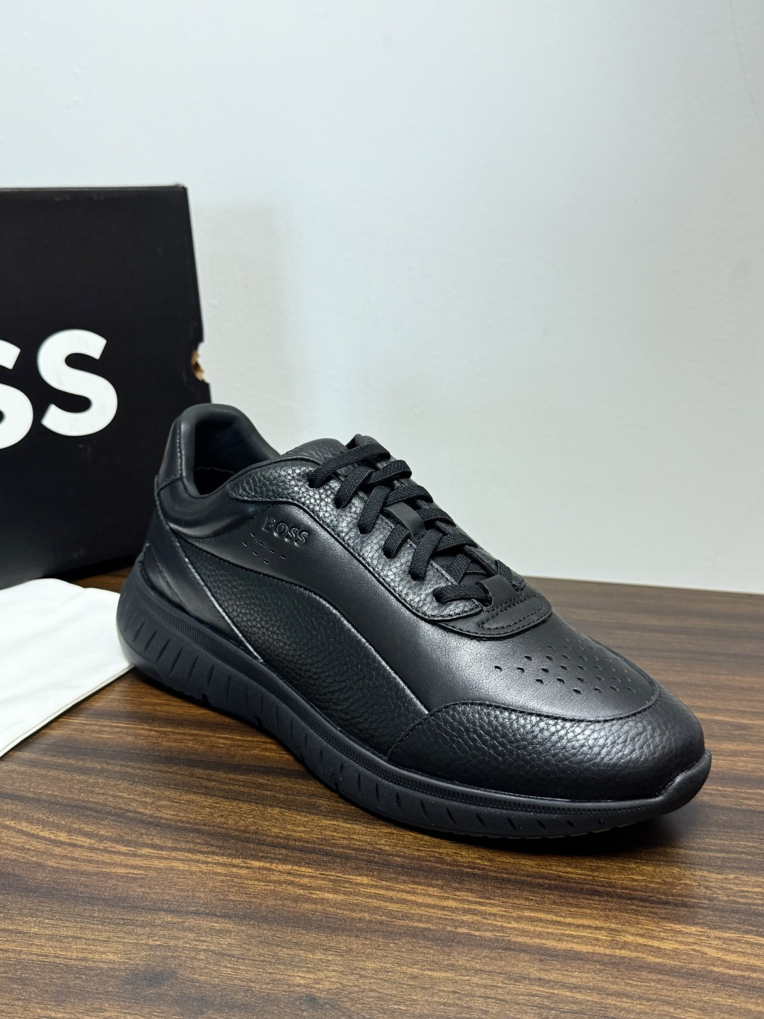 Hugo Boss 男士皮质休闲板鞋,鞋面是 荔枝纹牛皮 / 纳帕皮 ,鞋身有透气打孔设计,侧面压印或金属 BOSS Hugo Boss 男士皮质休闲板鞋,鞋面是 荔枝纹牛皮 / 纳帕皮 ,鞋身有透气打孔设计,侧面压印或金属 BOSS