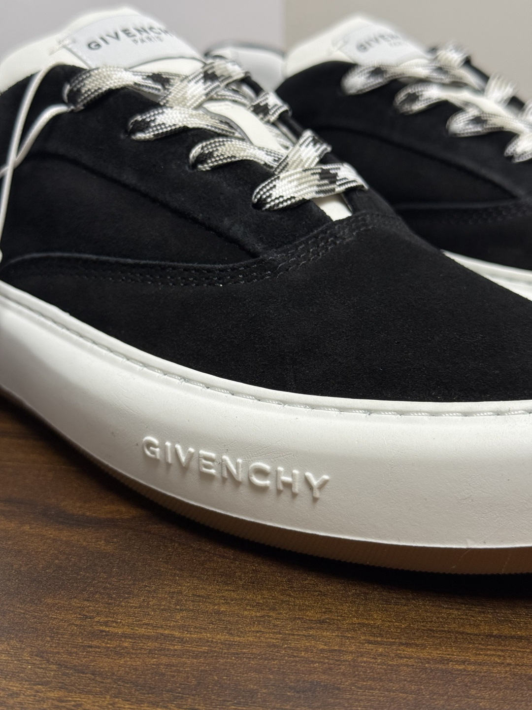 Givenchy 麂皮板鞋​​，鞋面是 ​​全麂皮​​材质，质感柔软有绒毛感，白色橡胶厚底侧面压印 GIVENCHY 字
