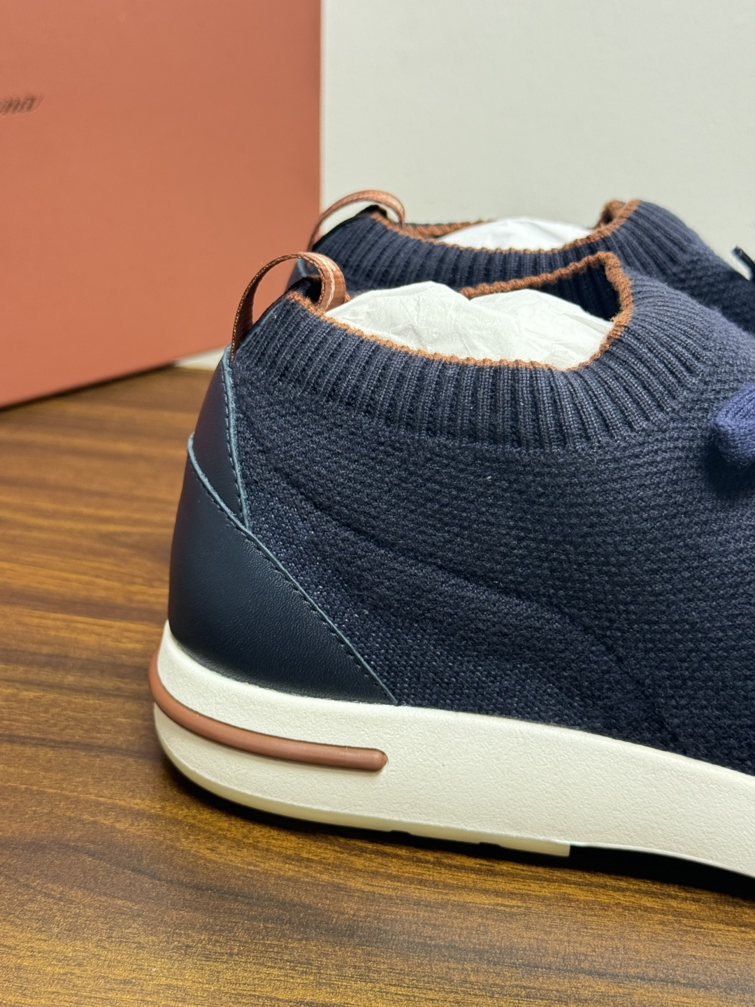 Loro Piana 针织袜套鞋​​，鞋面是针织/网眼袜套设计，整体造型是"静奢运动风"——远看像普通运动鞋，近看质感拉